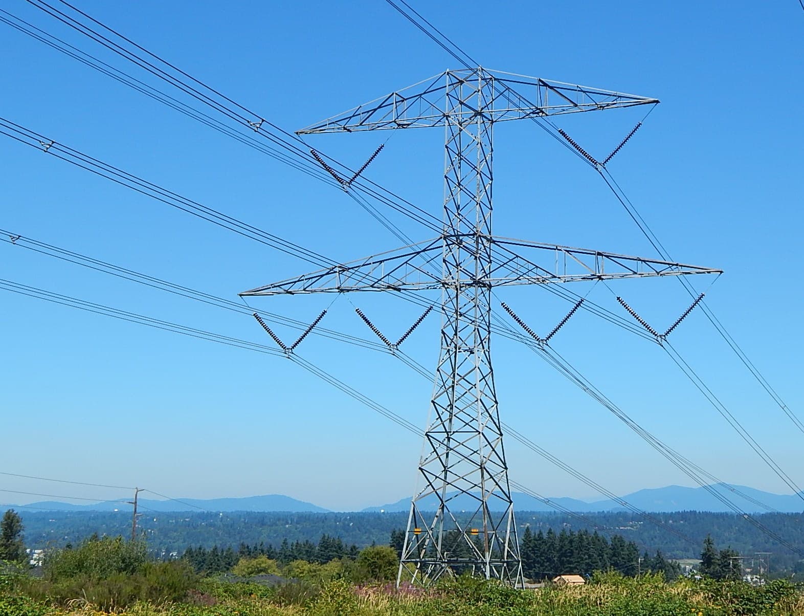 Torre de alta tensión con líneas eléctricas vista desde el exterior